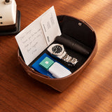 Brown full-grain leather valet tray holding a wallet, keys and everyday essentials