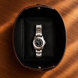 Brown leather valet tray with a black wristwatch and silver-tone hardware