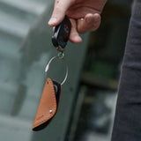 Key organizer in brown leather with car key assembled