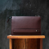 Close-up of full-grain Italian leather texture and double-stitched seams on travel organizer