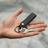 Black leather keyring in hands