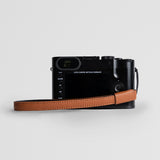 Brown full-grain Italian leather camera strap with brass hardware - minimalist adjustable design for DSLR and film cameras