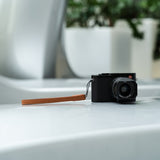 Close-up of vegetable-tanned brown leather texture and hand-stitched seams - shows OCULT's artisanal craftsmanship