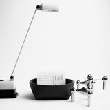 Minimalist brown leather valet tray styled with modern desk accessories