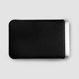 Black leather wallet on a light gray background