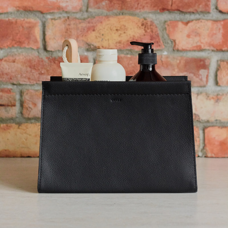 Minimalist leather dopp kit. Leather toiletry bag for men. Black color. Opened with Grooming Products