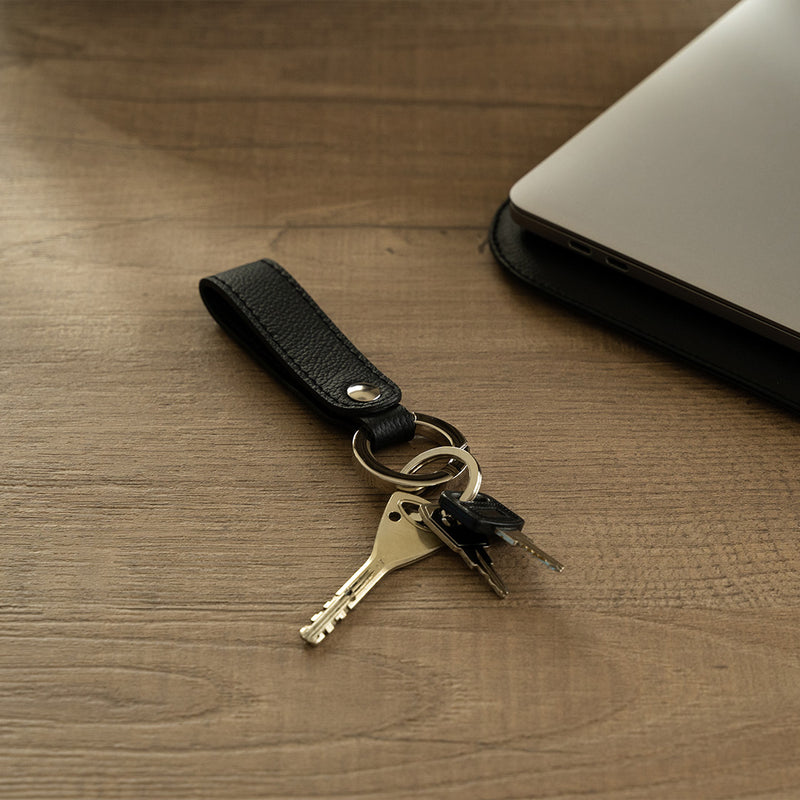Black leather keyring on the table
