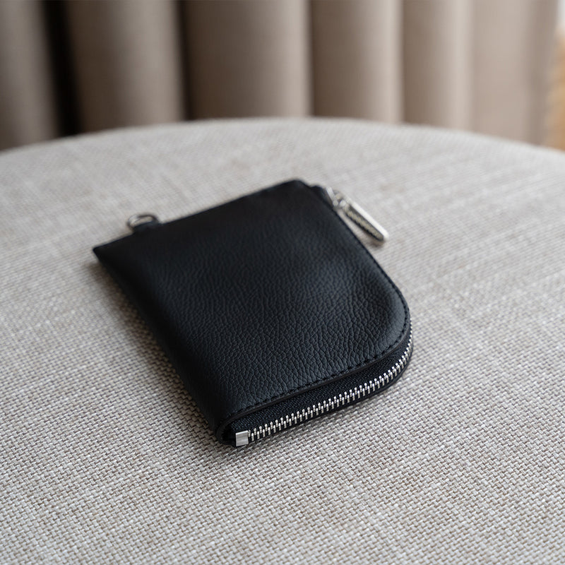 Black Leather Zip Wallet on a Sofa