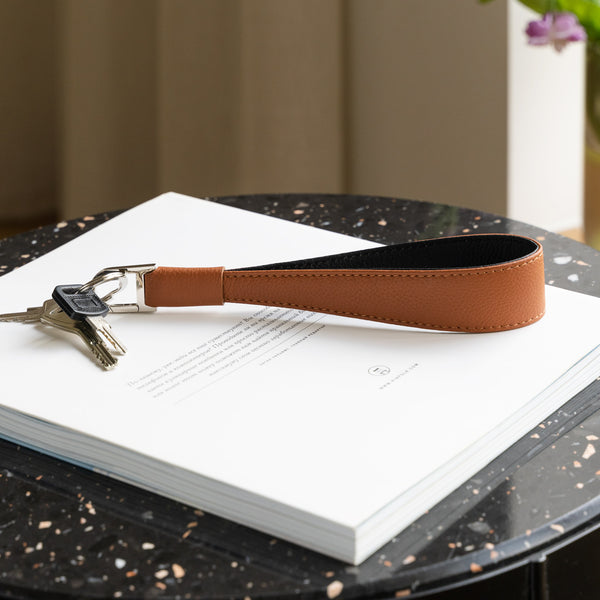 Brown leather long keyring on the table